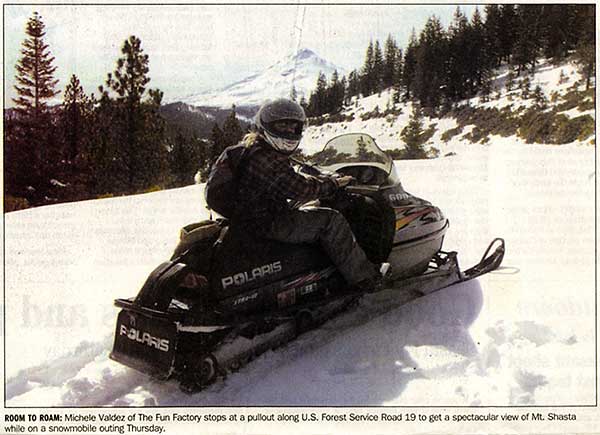 Image: Room To Roam: Michele Valdez of The Fun Factory stops at a pullout along U.S. Forest Service Road 19 to get a spectacular view of Mt. Shasta while on a snowmobile outing Thursday.