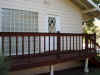 Rear bedroom deck.  Also showing a wall of glass bricks that lights up a sunken bathtub.